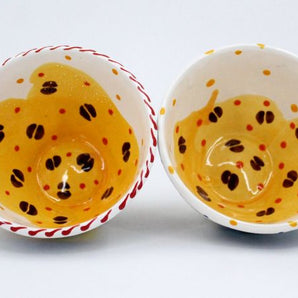 Colorful ceramic cup with coffee beans