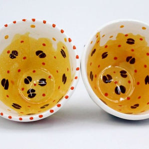 Beautiful ceramic cup with coffee beans