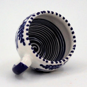 White and blue ceramic teacup hand painted