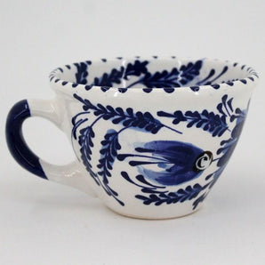 White and blue ceramic coffee cup, hand painted