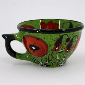 Green ceramic teacup with poppies