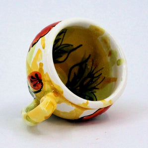 Colorful ceramic coffee cup with poppies