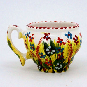 Pottery cup painted with small flowers