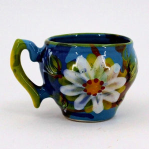 Hand-painted clay cup with daisies