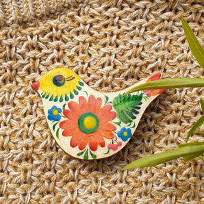 Wooden bird brooch with floral pattern