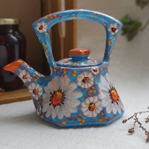 Small hand-painted clay teapot with chamomile flowers