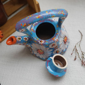 Small hand-painted clay teapot with chamomile flowers