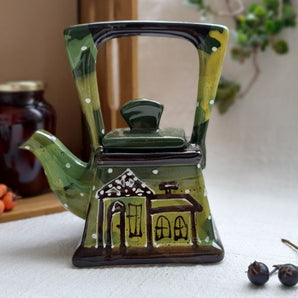 Small pottery teapot with house motifs, hand-painted