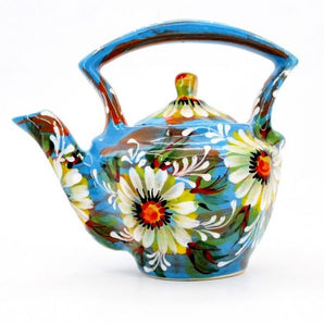 Blue ceramic teapot with daisies