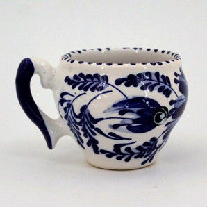 White and blue ceramic teacup hand painted