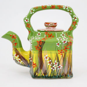 Small clay teapot hand-painted with flowers