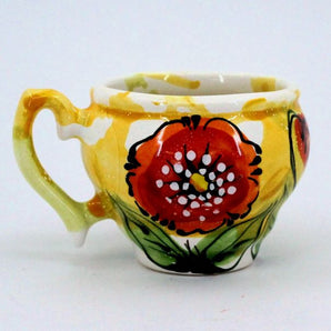 Colorful ceramic coffee cup with poppies