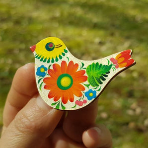 Wooden bird brooch with floral pattern