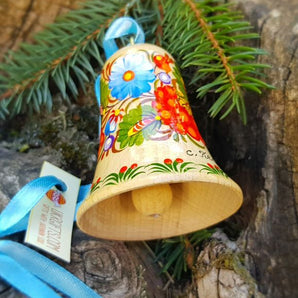 Hand-painted bell with floral pattern made of natural wood