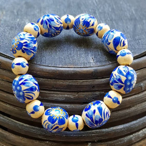 Handmade bracelet with blue flowers made of wooden beads