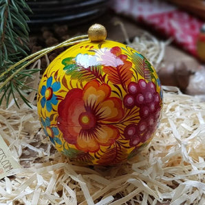 Yellow Christmas ball painted with floral pattern