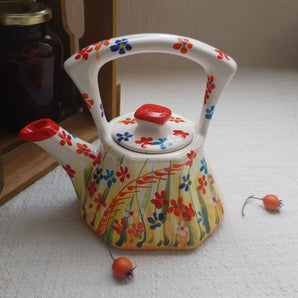 Small hand-painted ceramic teapot with floral pattern