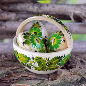 Small wooden Easter basket and Easter eggs with green floral pattern