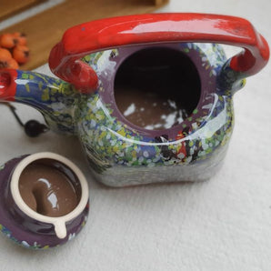 Colorful ceramic teapot with spring motifs