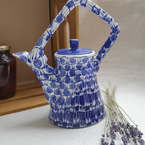 Design teapot made of clay with blue pattern