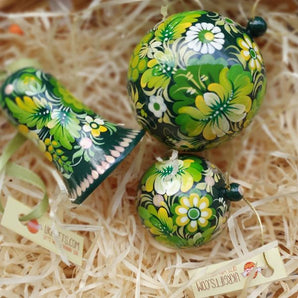 Green hand-painted Christmas balls and bells with floral pattern, traditional handicraft