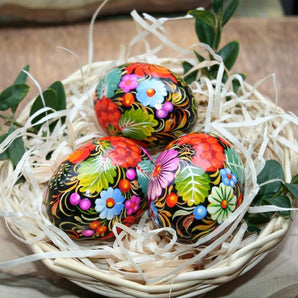 Traditional Ukrainian Easter eggs with Petrykivka painting in a basket - Easter decoration
