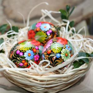 Traditional Ukrainian Easter eggs with Petrykivka painting in a basket - Easter decoration