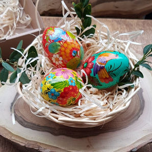 Hand-painted wooden Easter eggs in a basket - Ukrainian handicrafts