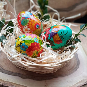 Hand-painted wooden Easter eggs in a basket - Ukrainian handicrafts