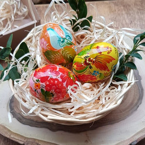 Easter table decoration natural materials - colorful wooden Easter eggs in a basket