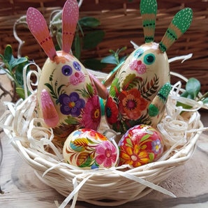 Funny Easter rabbits with 3 small Easter eggs in the basket