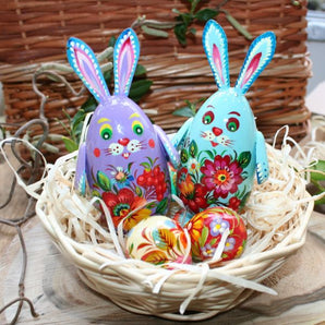 Easter decoration bunnies and small wooden Easter eggs in a basket - high-quality Easter gifts