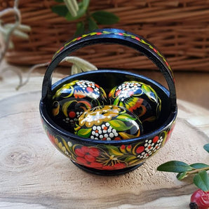 Traditional painted Easter eggs in a small wooden basket