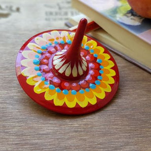 Spinning top, traditional wooden toy with geometric ornament, hand painted