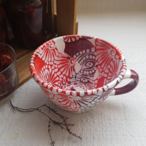 Hand-painted ceramic cup with abstract pattern - handicraft