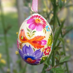 Wooden Easter egg with flowers and bird designed in Ukraine