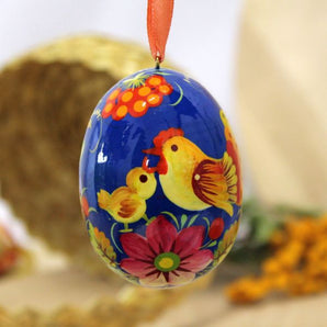 Wooden Easter egg pysanka with bird und flowers patterns