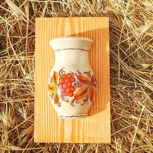 Rustic wooden wall deco, small vase with orange flowers