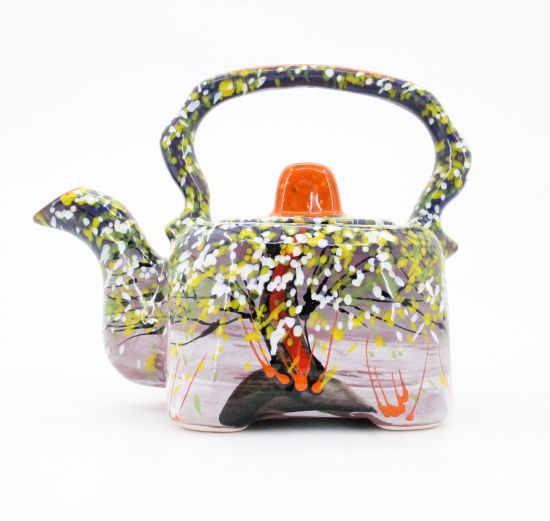 Colorful ceramic teapot with spring motifs