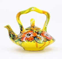 Yellow pottery teapot with poppies