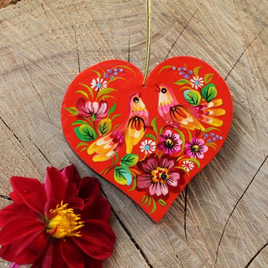 Red Christmas ornaments in heart shape with Petrykivka painting