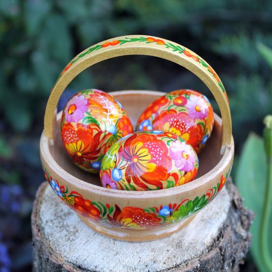 Handcrafted wooden Easter dekoration basket with Easter eggs