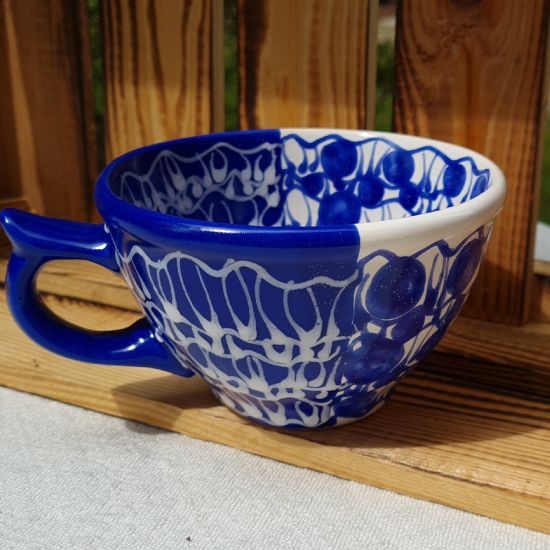 Handmade blue ceramic cup with abstract ornaments