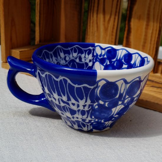 Handmade blue ceramic cup with abstract ornaments