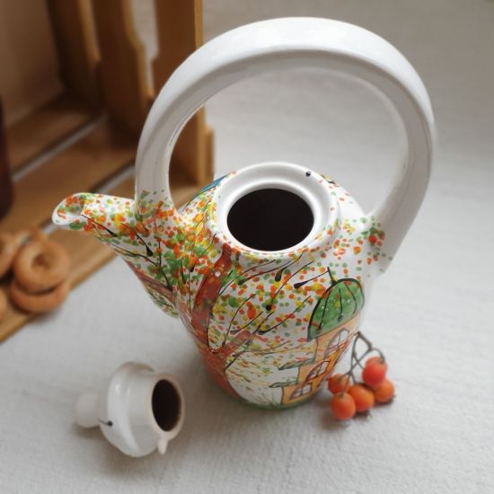 Design clay teapot with houses
