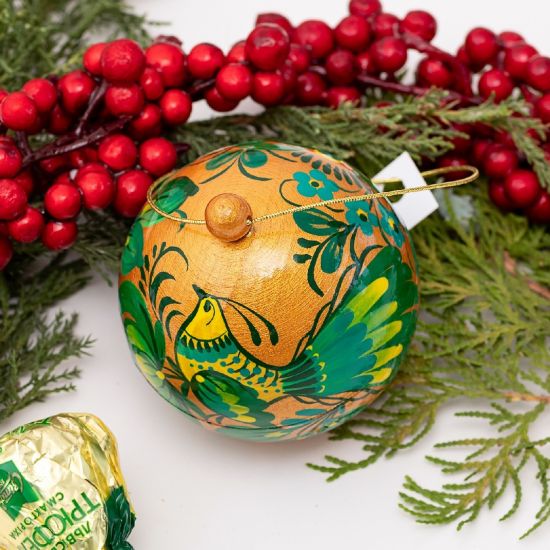 Gold-green wooden Сhristmas ball hand painted with bird motif