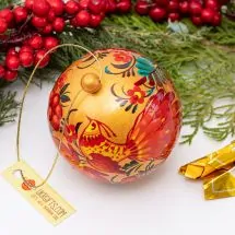 Gold-red Christmas ball artisticall hand painted with a bird motif