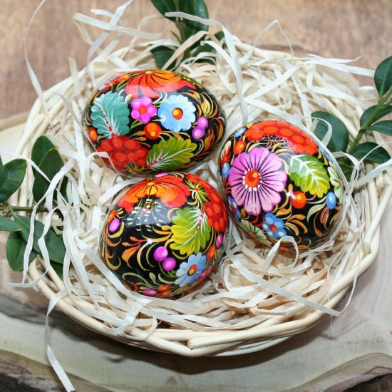 Traditional Ukrainian Easter eggs with Petrykivka painting in a basket - Easter decoration
