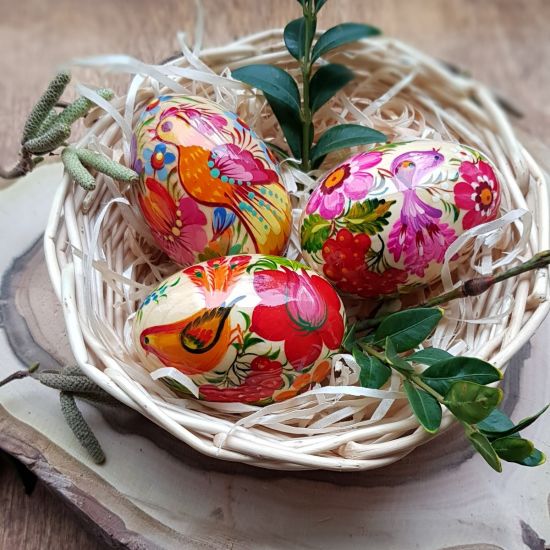 Easter decoration - hand painted wooden Easter eggs in a basket