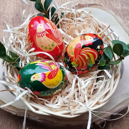 Traditional Ukrainian Easter eggs hand-painted, made of wooden 3 pieces in a basket
